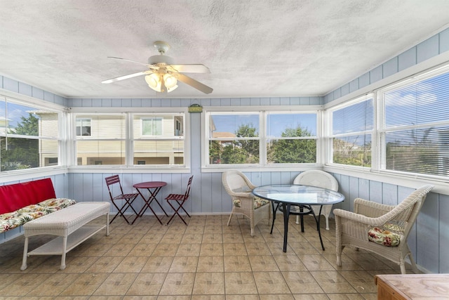 sunroom / solarium with a healthy amount of sunlight and a ceiling fan