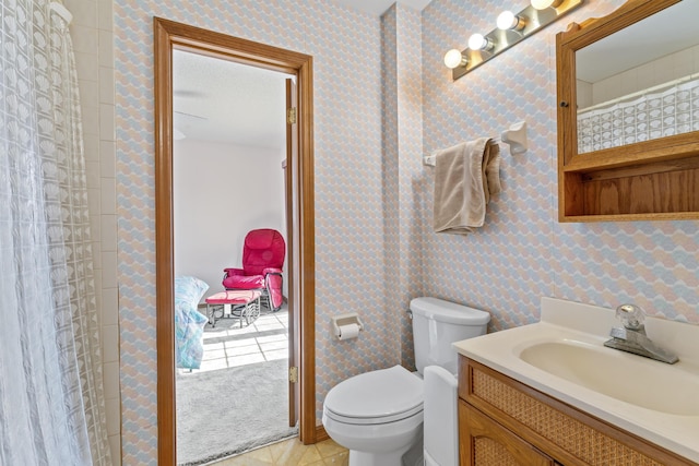 full bath with toilet, wallpapered walls, vanity, and tile patterned floors