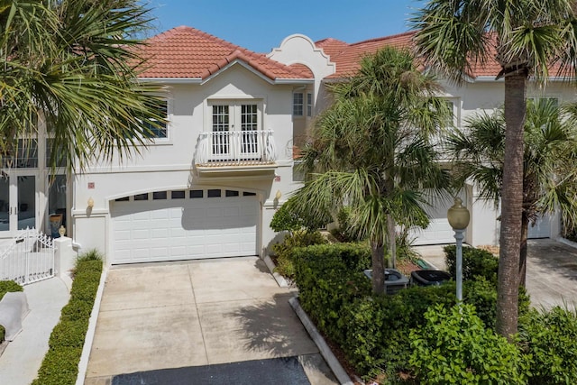 616 Mediterranean Way, Saint Augustine, FL 32080 - mediterranean / spanish home with french doors, stucco siding, a balcony, a tiled roof, and driveway