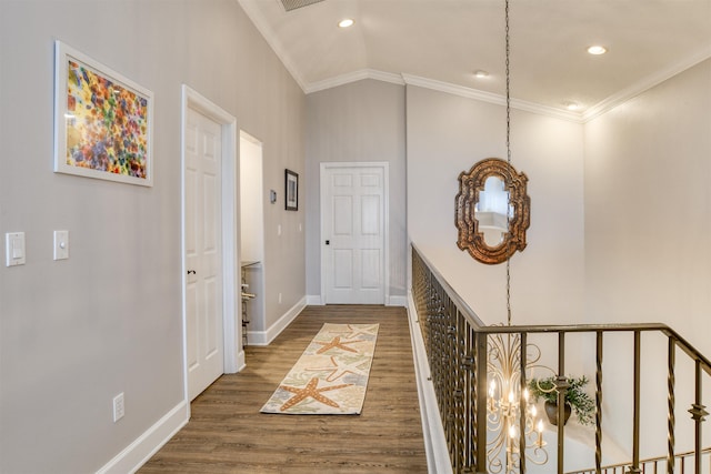 hall with vaulted ceiling, dark wood-type flooring, and ornamental molding