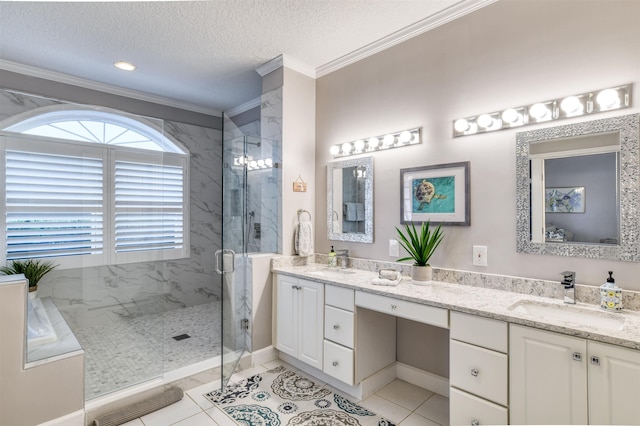 bathroom featuring tile patterned flooring, a textured ceiling, walk in shower, ornamental molding, and vanity