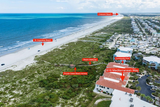 birds eye view of property with a water view and a view of the beach