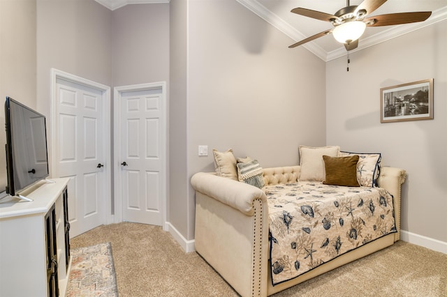 living area featuring ceiling fan, crown molding, and light carpet