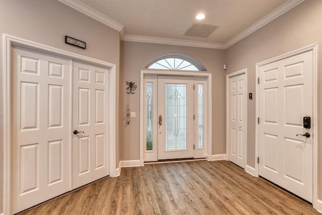 entrance foyer featuring light hardwood / wood-style flooring and ornamental molding