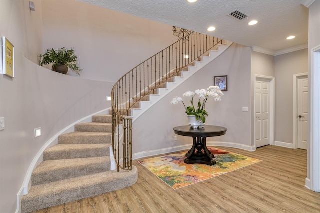 616 Mediterranean Way, Saint Augustine, FL 32080 - staircase with wood finished floors, recessed lighting, crown molding, and a textured ceiling