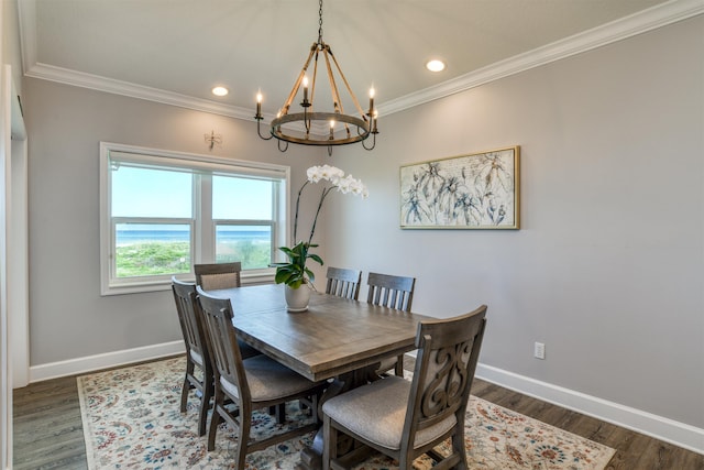 dining room with crown molding, dark hardwood / wood-style floors, and a notable chandelier