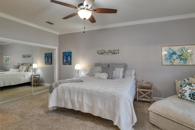 carpeted bedroom with ceiling fan, crown molding, a textured ceiling, and a closet