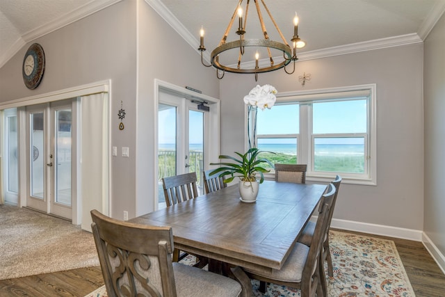 dining space with ornamental molding, plenty of natural light, and an inviting chandelier