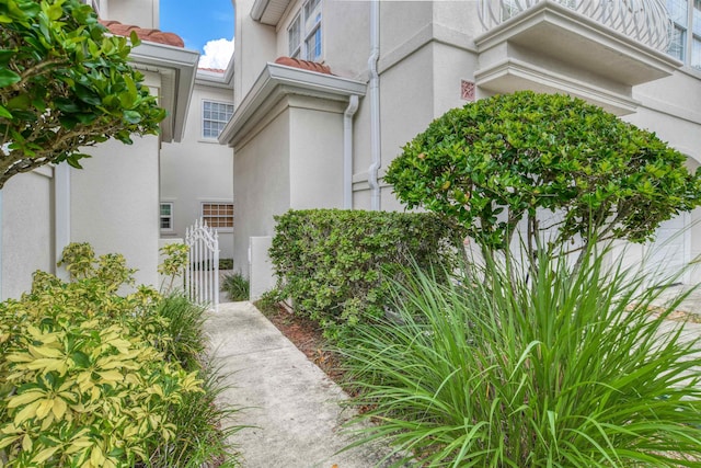 616 Mediterranean Way, Saint Augustine, FL 32080 - doorway to property with stucco siding and a gate