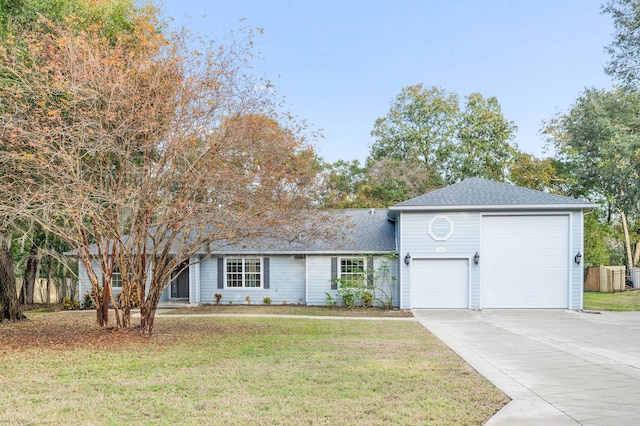 view of front of home with a garage and a front lawn