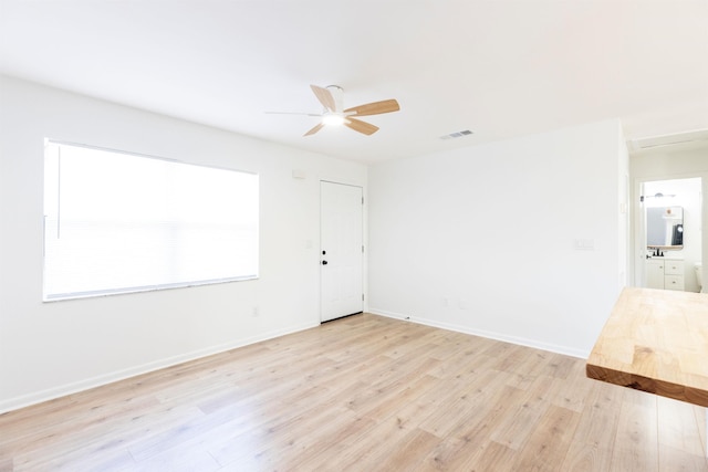 unfurnished room featuring ceiling fan and light hardwood / wood-style flooring