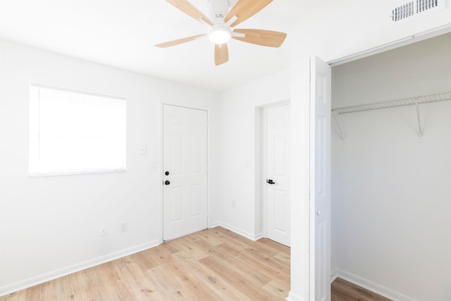 unfurnished bedroom featuring light hardwood / wood-style flooring, a closet, and ceiling fan