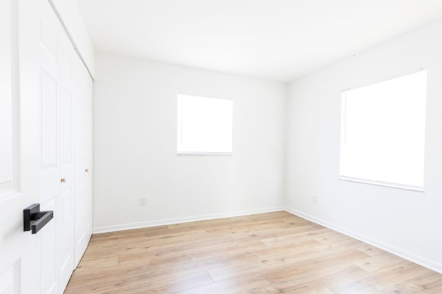 spare room featuring light wood-type flooring