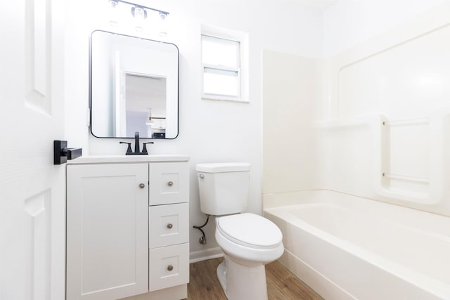 full bathroom featuring wood-type flooring, vanity, washtub / shower combination, and toilet