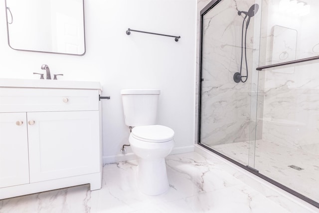 bathroom with vanity, a shower with door, and toilet