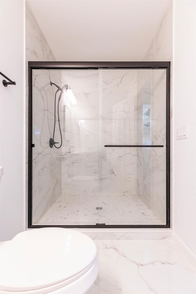 bathroom with a shower with door