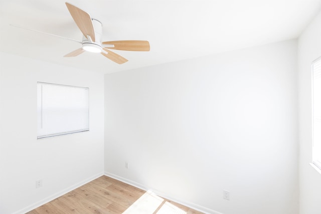 spare room with plenty of natural light, ceiling fan, and light wood-type flooring