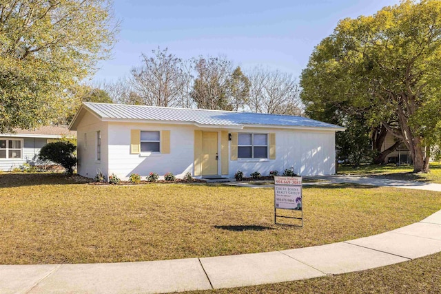 ranch-style home with a front lawn