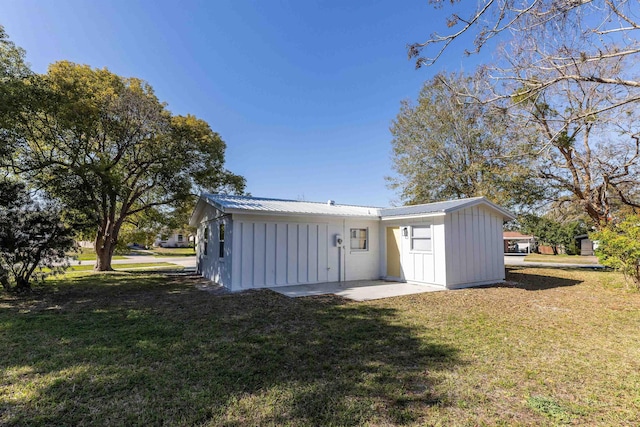 back of house featuring a patio and a lawn