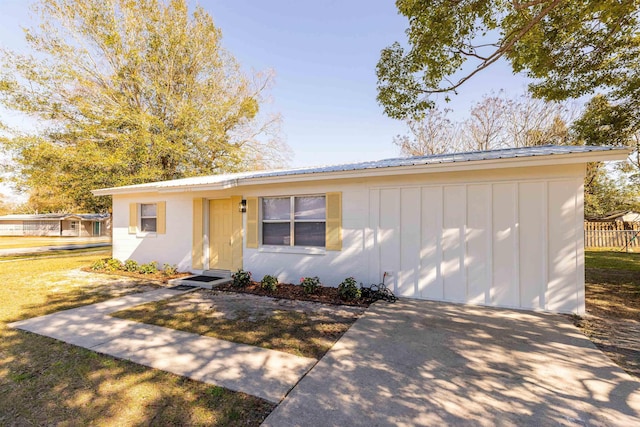 202 Deltona Blvd, Saint Augustine, FL 32086 - ranch-style house with board and batten siding, a front lawn, and metal roof
