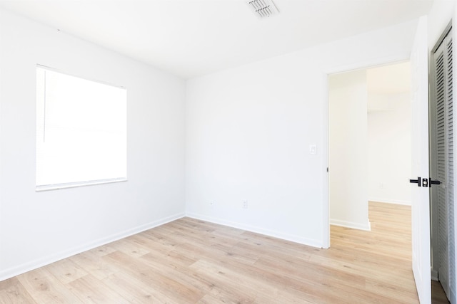 empty room with light hardwood / wood-style floors