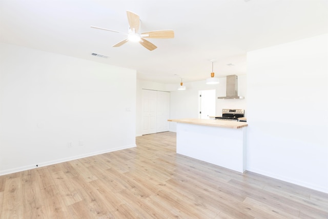 unfurnished living room featuring light hardwood / wood-style flooring and ceiling fan