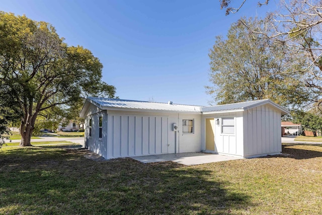 back of property featuring a yard