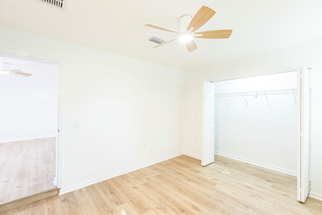 unfurnished bedroom with ceiling fan, a closet, and light hardwood / wood-style flooring