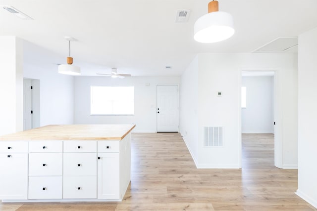 202 Deltona Blvd, Saint Augustine, FL 32086 - kitchen featuring a ceiling fan, white cabinetry, light wood finished floors, and baseboards