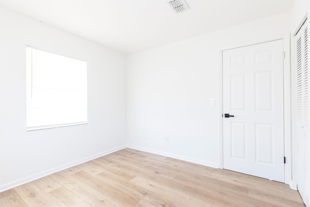 spare room featuring light wood-type flooring