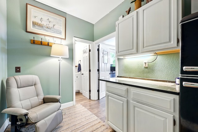 133 Federal Point Rd, East Palatka, FL 32131 - kitchen featuring light wood finished floors, baseboards, freestanding refrigerator, and white cabinets