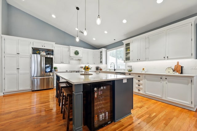 133 Federal Point Rd, East Palatka, FL 32131 - kitchen with stainless steel appliances, tasteful backsplash, wine cooler, a kitchen bar, and white cabinets