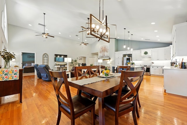 133 Federal Point Rd, East Palatka, FL 32131 - dining area featuring ceiling fan with notable chandelier, high vaulted ceiling, visible vents, recessed lighting, and light wood finished floors