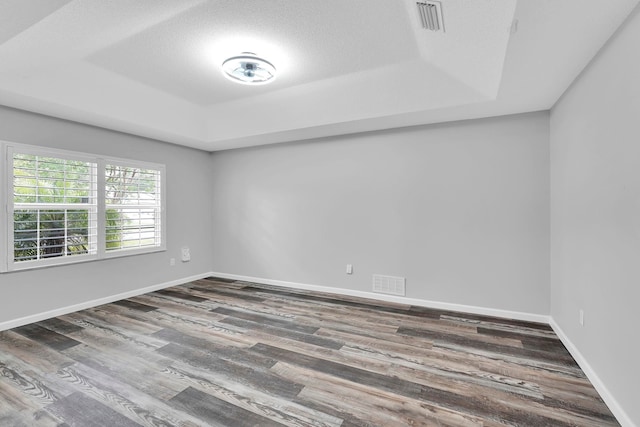 61 Brownstone Ln, Palm Coast, FL 32137 - unfurnished room with a tray ceiling and wood finished floors
