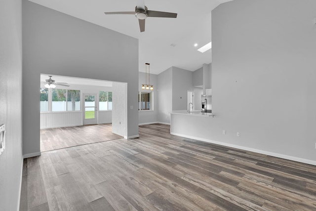 61 Brownstone Ln, Palm Coast, FL 32137 - unfurnished living room with ceiling fan, high vaulted ceiling, and wood finished floors