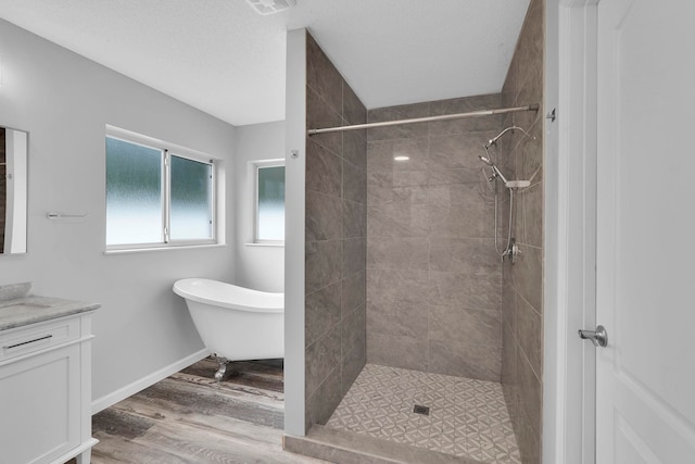 61 Brownstone Ln, Palm Coast, FL 32137 - full bathroom featuring vanity, wood finished floors, a stall shower, and a freestanding tub