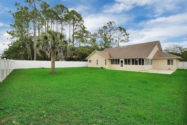 61 Brownstone Ln, Palm Coast, FL 32137 - back of property featuring a fenced backyard, a patio area, stucco siding, roof with shingles, and a sunroom
