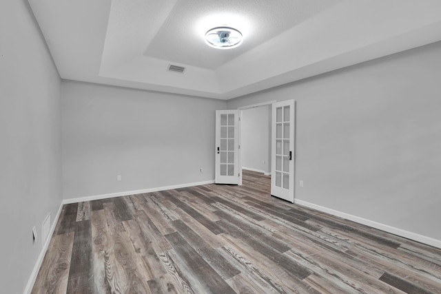 61 Brownstone Ln, Palm Coast, FL 32137 - unfurnished room featuring french doors, a tray ceiling, and wood finished floors