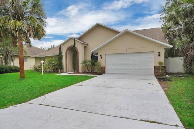 61 Brownstone Ln, Palm Coast, FL 32137 - view of front facade with brick siding, driveway, a garage, and stucco siding