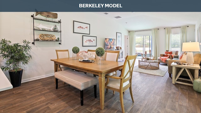 dining space featuring dark wood-type flooring and lofted ceiling