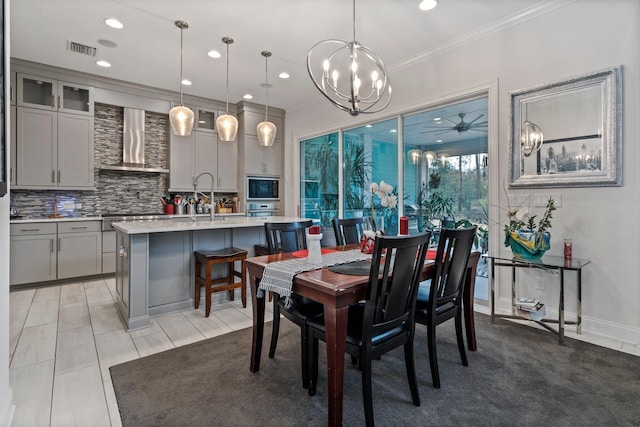 dining space featuring ornamental molding, light tile patterned flooring, and ceiling fan