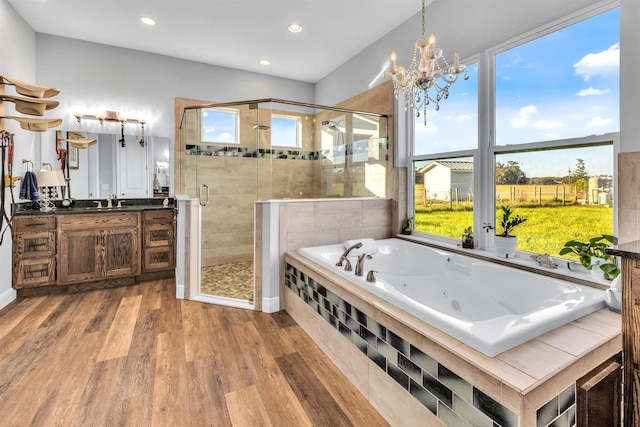 14465 Andalusia Trl, Bunnell, FL 32110 - bathroom featuring a stall shower, a whirlpool tub, plenty of natural light, and wood finished floors