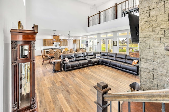 14465 Andalusia Trl, Bunnell, FL 32110 - living area with an inviting chandelier, recessed lighting, a towering ceiling, and wood finished floors