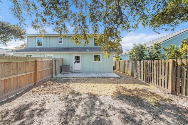 112 2nd St, Saint Augustine, FL 32080 - back of property featuring a patio, a fenced backyard, central AC unit, and board and batten siding