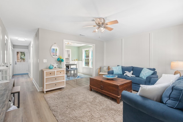 112 2nd St, Saint Augustine, FL 32080 - living area with light wood finished floors, a ceiling fan, and baseboards