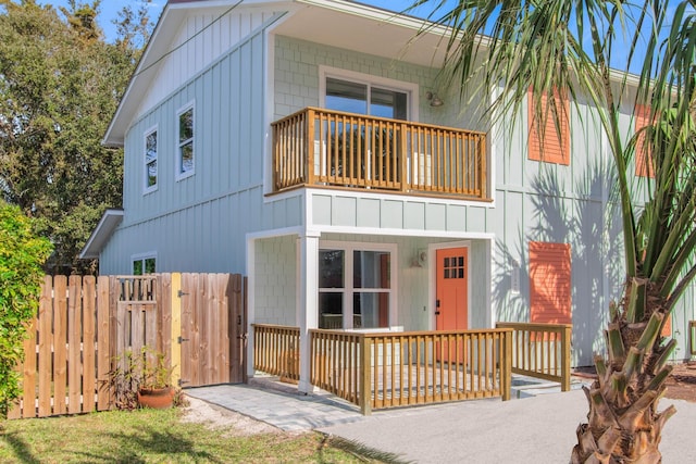 112 2nd St, Saint Augustine, FL 32080 - view of front of property with a balcony, a gate, and board and batten siding