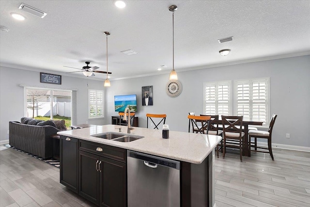 kitchen featuring visible vents, open floor plan, dishwasher, plenty of natural light, and a sink