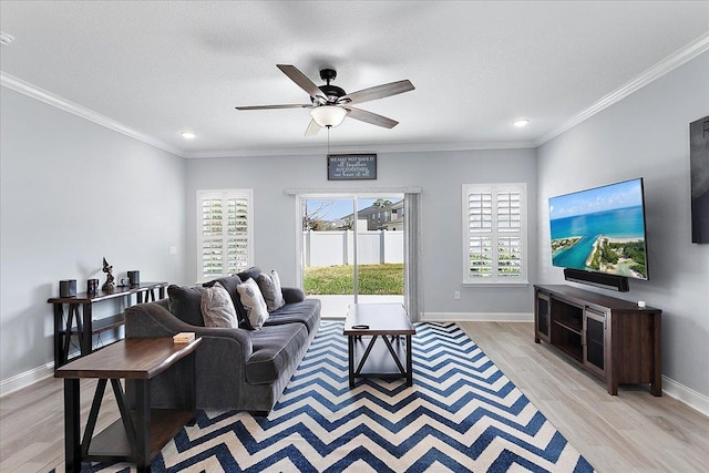 living room with baseboards, ornamental molding, and light wood finished floors