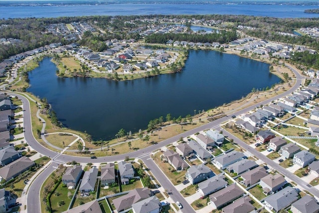 drone / aerial view with a residential view and a water view