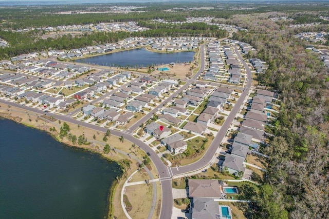 drone / aerial view with a residential view and a water view